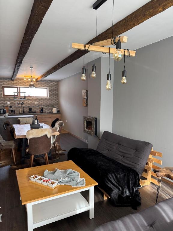 a living room with a couch and a table at Boris’s Guest Apartment in Chepelare