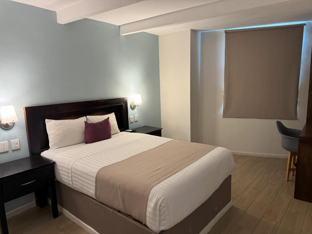 Postel nebo postele na pokoji v ubytování Hotel Arribo