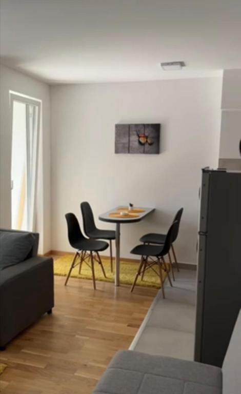 a living room with a table and chairs at For You in Vrnjci