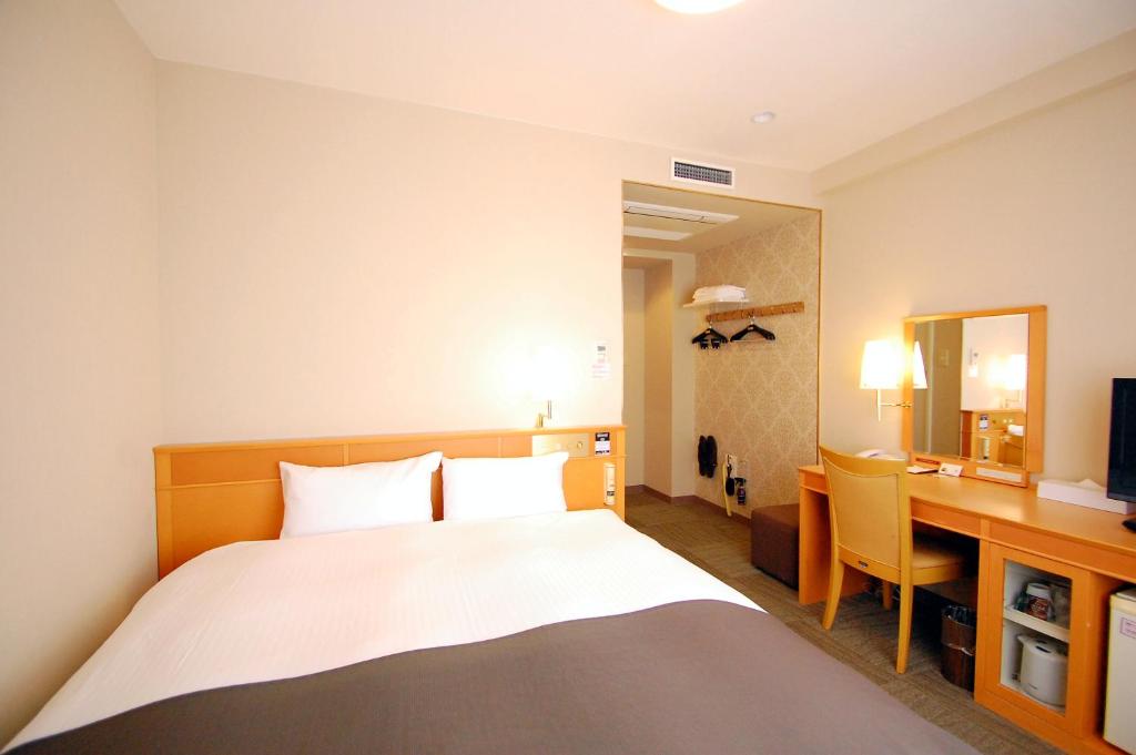 Postel nebo postele na pokoji v ubytování Izumo Royal Hotel