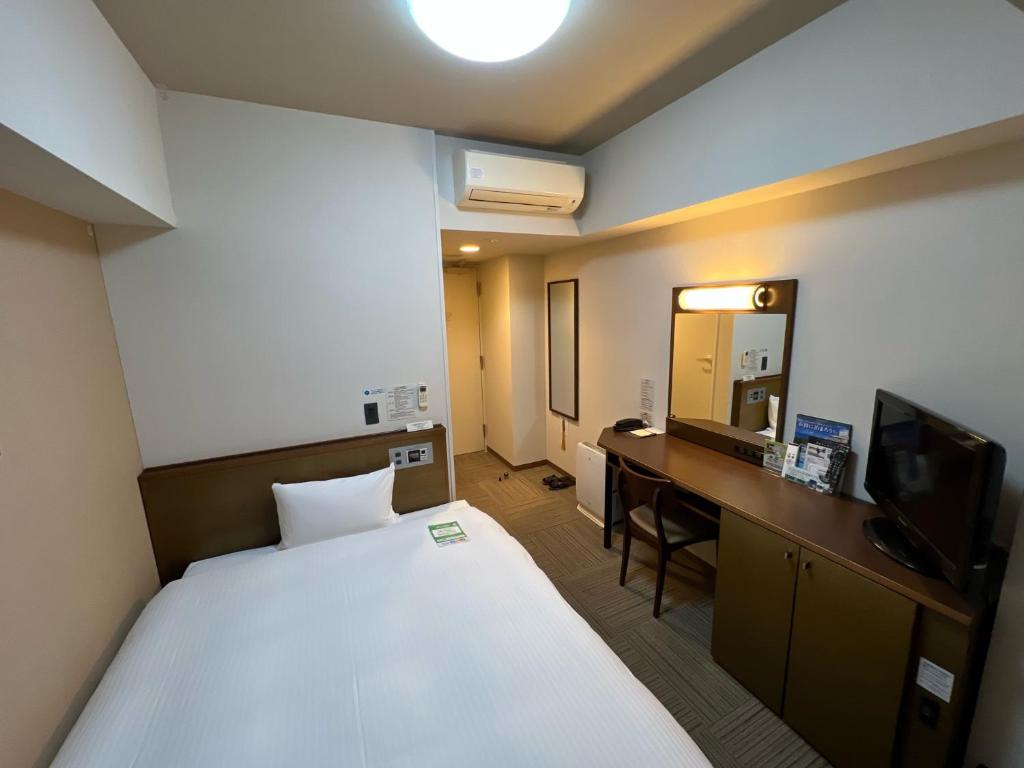 Postel nebo postele na pokoji v ubytování Hotel Route-Inn Uozu