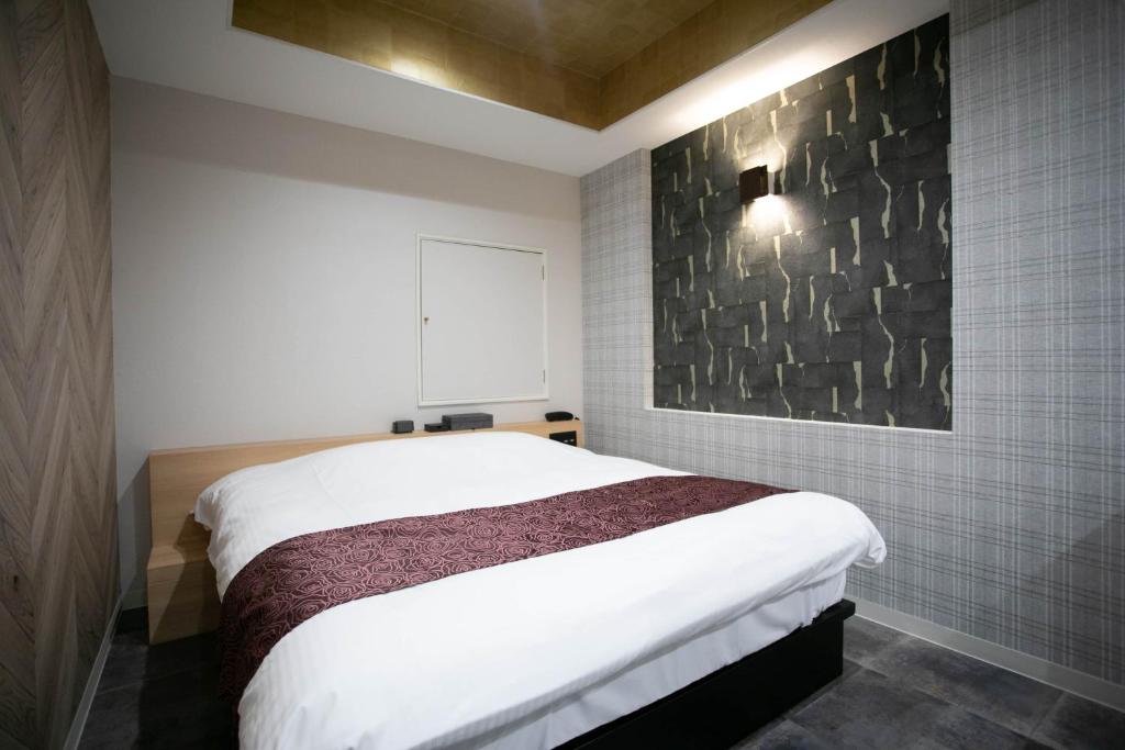 Postel nebo postele na pokoji v ubytování Hotel TEMARI Matsumoto