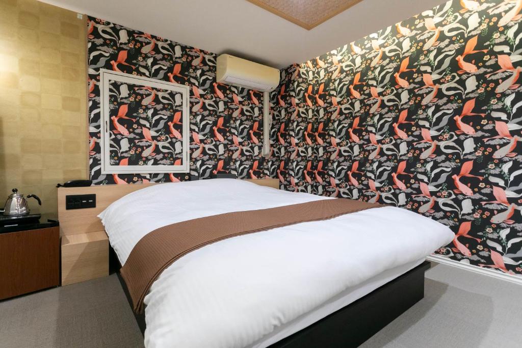 Postel nebo postele na pokoji v ubytování Hotel TEMARI Matsumoto
