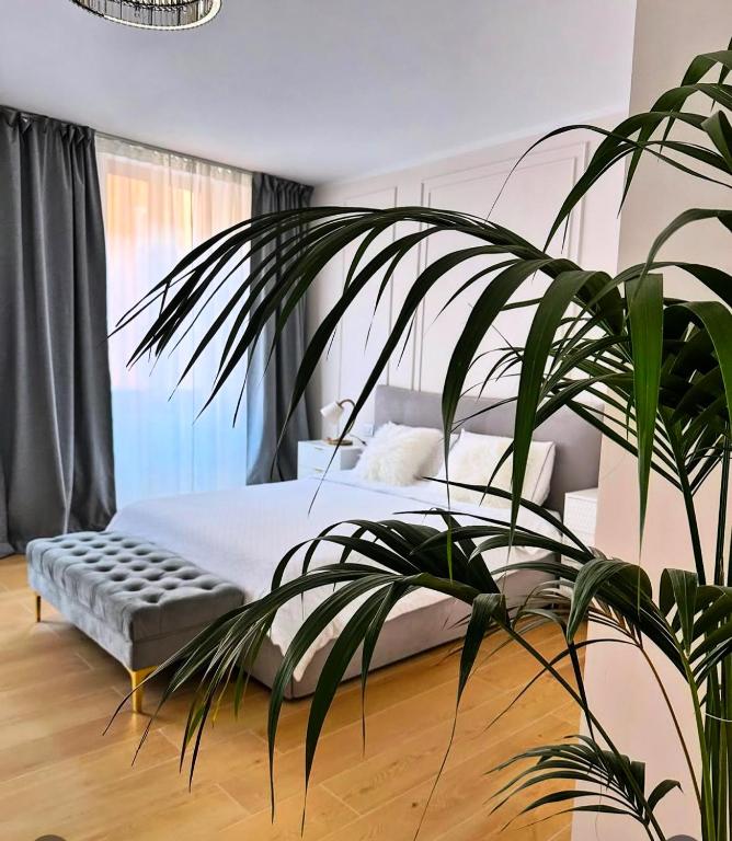 a bedroom with a bed and a large plant at LB - Luna Luxury Suite in Bergamo