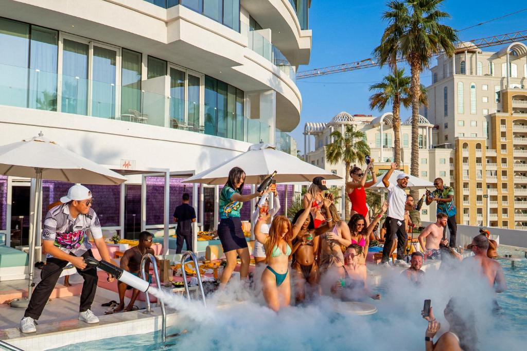 a group of people playing in the water at a pool at FIVE Jumeirah Village in Dubai