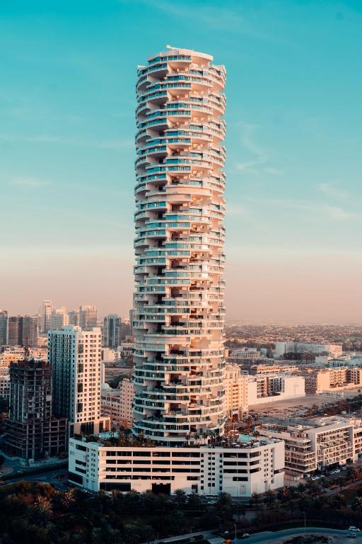 a large tall building in a city with buildings at FIVE Jumeirah Village in Dubai