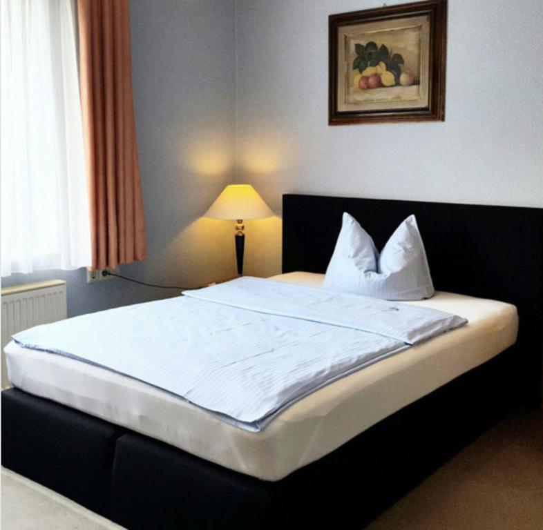 Postel nebo postele na pokoji v ubytování Occhipinti Passione - Restaurant & Hotel - Weyhausen
