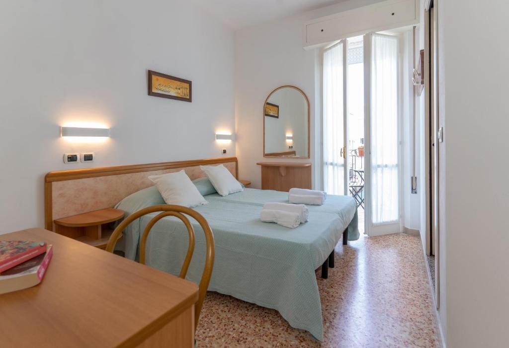 Postel nebo postele na pokoji v ubytování Hotel Greta B&B