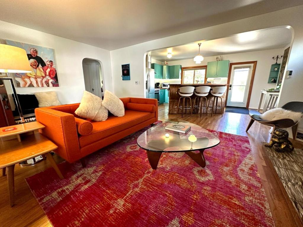 a living room with an orange couch and a table at Downtown Solvang l Most Desired Home l 2BR in Solvang