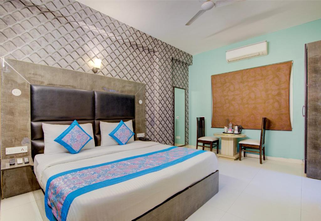 a bedroom with a large bed in a room at Hotel Smart Signature in New Delhi