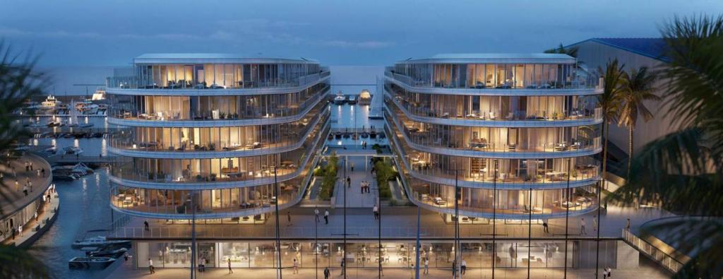 two tall buildings with lights on in a city at Genoa Downtown East Water Front in Genova