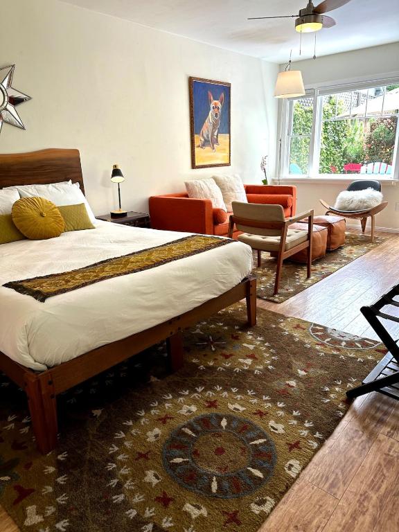 a bedroom with a bed and a living room at Couples Cottage l Steps to Downtown in Solvang
