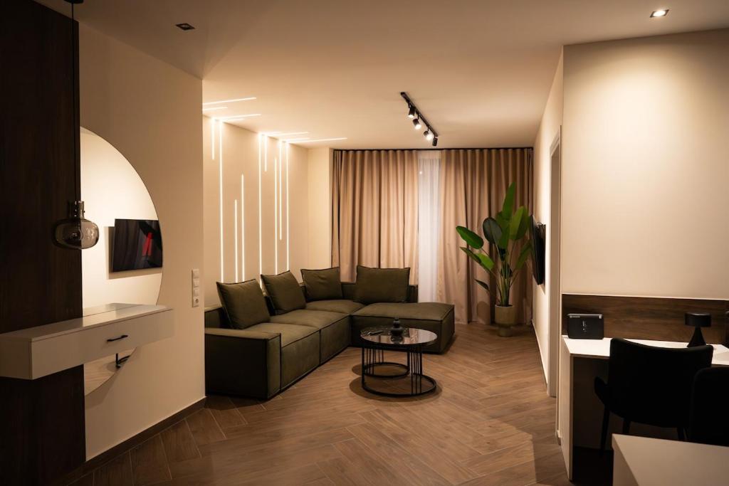 a living room with a couch and a table at Kalma Luxury Living Athens in Athens
