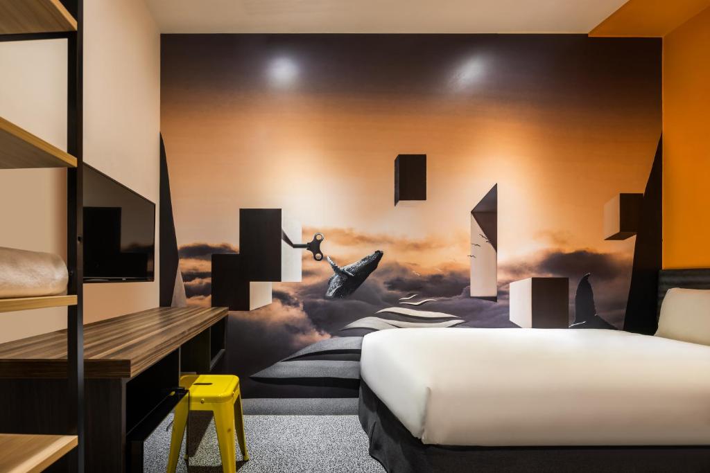 a bedroom with a bed and a wall with a painting at 凝萃文旅 台中車站店 NCH-Business Hotel in Taichung