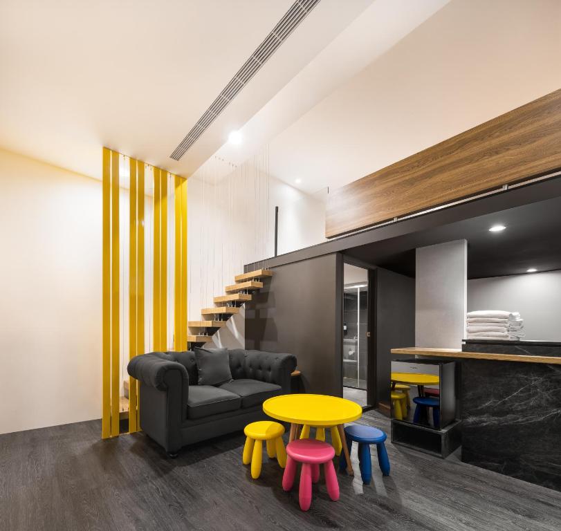 a living room with a couch and a table at 凝萃文旅 台中車站店 NCH-Business Hotel in Taichung