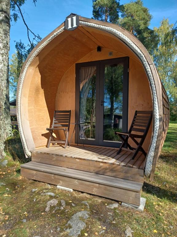 a round house with two chairs sitting on a deck at Pyhäranta Camping & Kievari in Pyhäranta