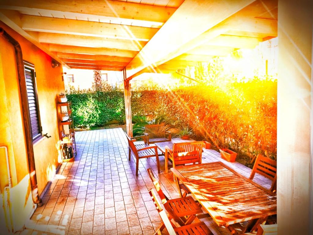 a patio with a wooden table and chairs at Da Vinci Apartment in Tortoreto Lido