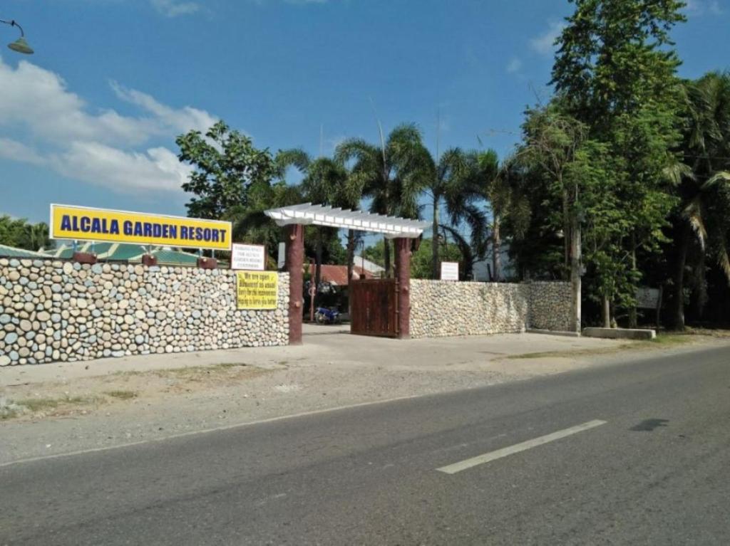 ein Schild für ein amerikanisches Barrierenkrankenhaus neben einer Straße in der Unterkunft RedDoorz @ Alcala Garden Resort in Alcala