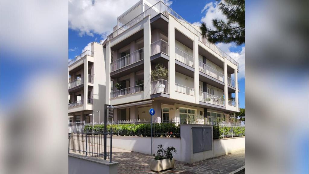 a white building with balconies on the side of it at Homiday - Luminoso in Pineto