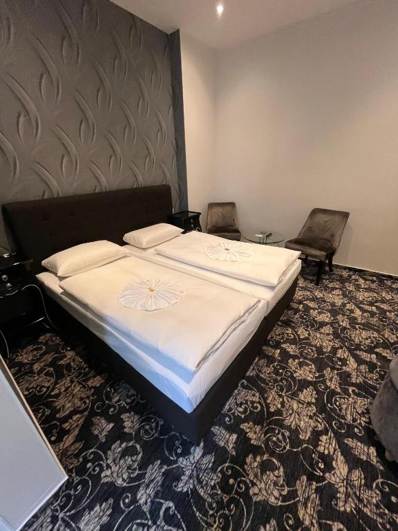 Postel nebo postele na pokoji v ubytování Hotel Gasteiner Hof