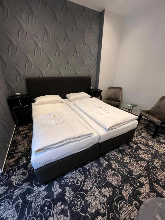 Postel nebo postele na pokoji v ubytování Hotel Gasteiner Hof