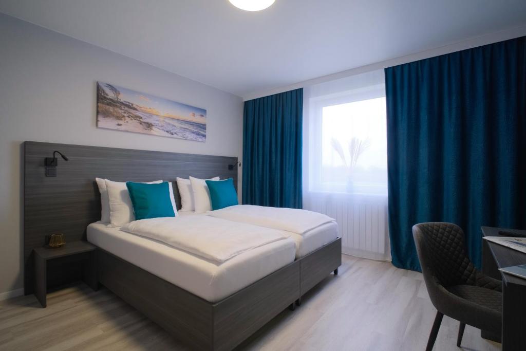 Postel nebo postele na pokoji v ubytování Hotel Kiel by MELIO