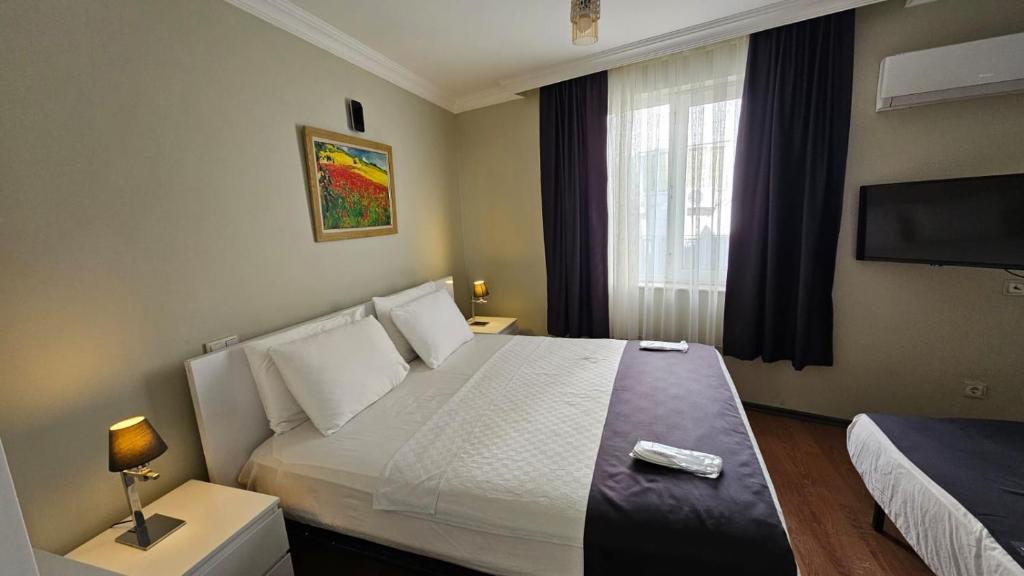 a hotel room with a bed and a television at Sever Hotel in Antalya