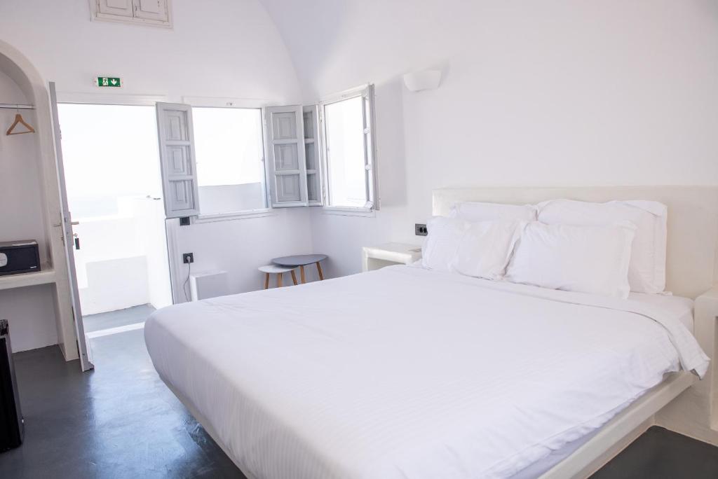 Postel nebo postele na pokoji v ubytování White Cave Villas