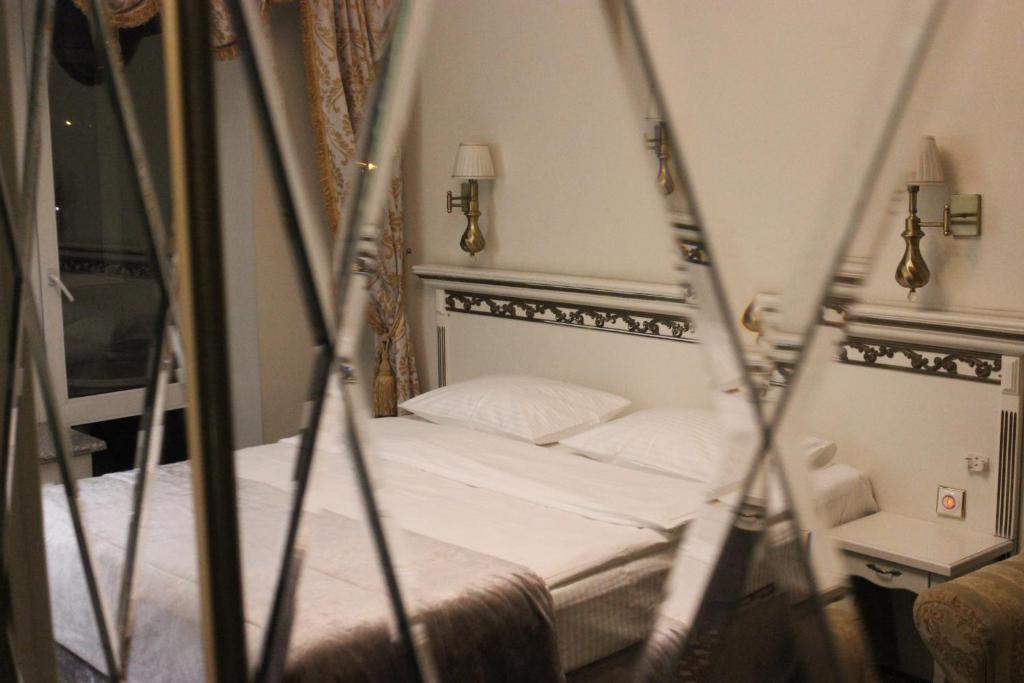 Postel nebo postele na pokoji v ubytování Royal City Hotel