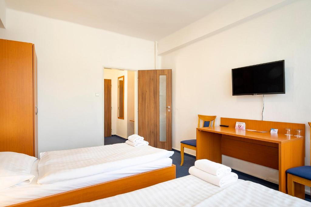 Postel nebo postele na pokoji v ubytování Hotel Veronika