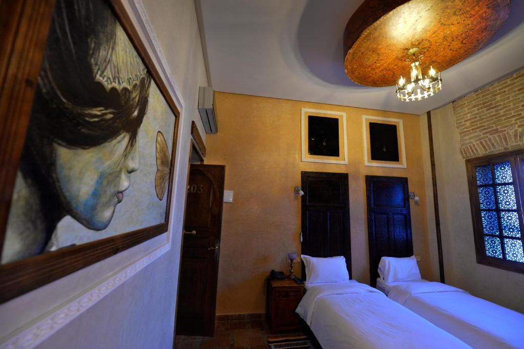 Postel nebo postele na pokoji v ubytování Hotel des Oudaias