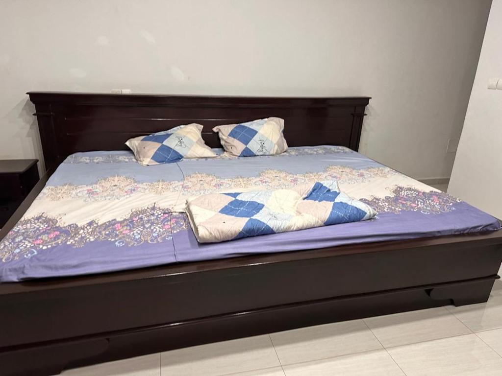 a bed with blue sheets and pillows on it at Villa cité in Zogbégan