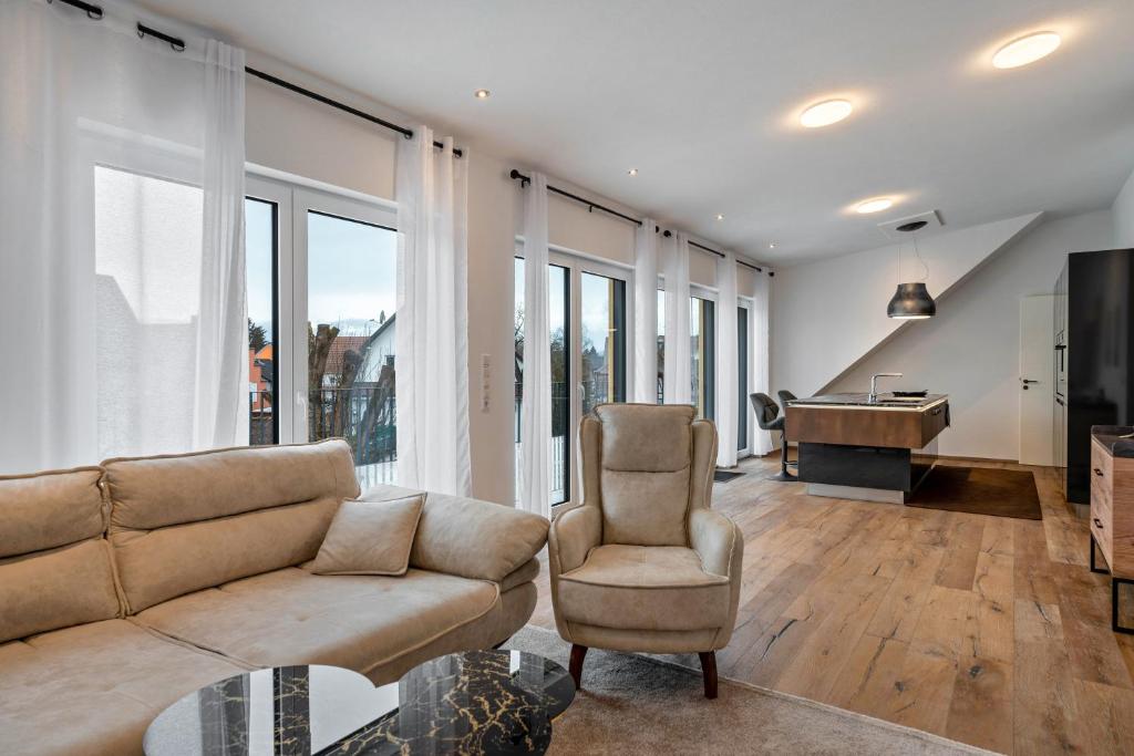 a living room with a couch and a piano at City Villa Bad Dürrheim - Penthouse in Bad Dürrheim