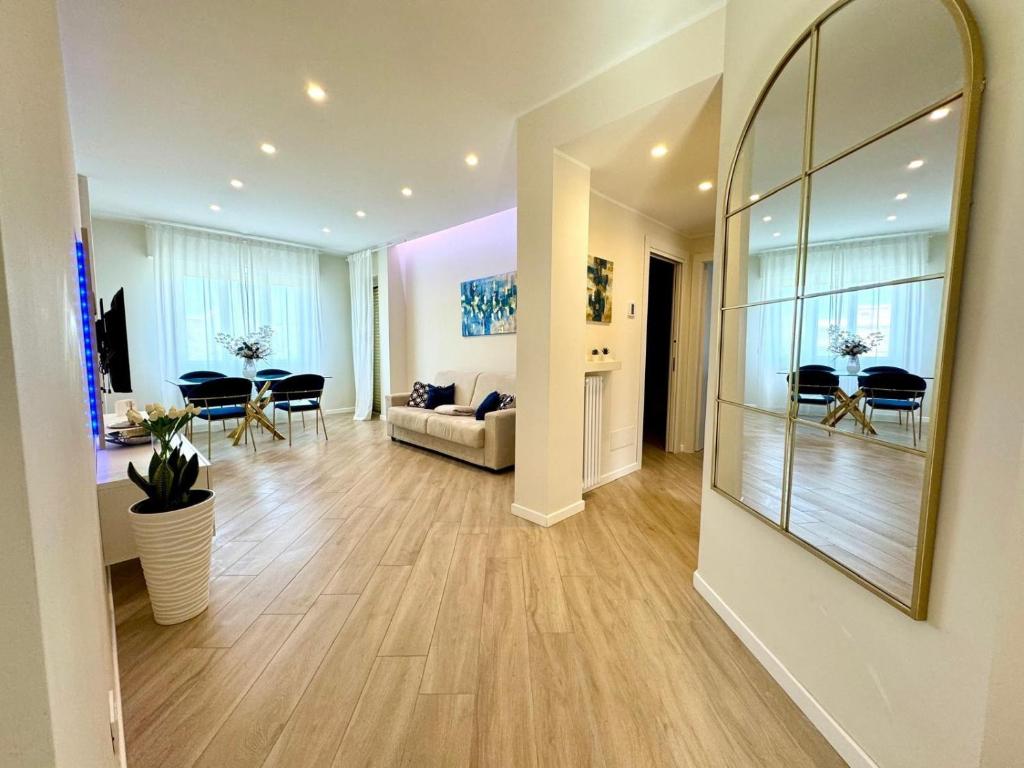 a living room with a large mirror on the wall at Blue Sea Apartment in Torvaianica