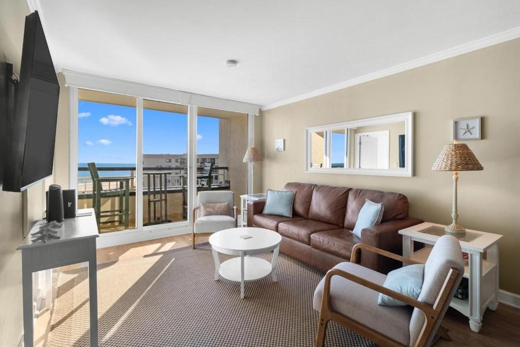 a living room with a couch and a view of the ocean at 5th Flr Oceanfront 2 Bedroom Condo in Pawleys Island