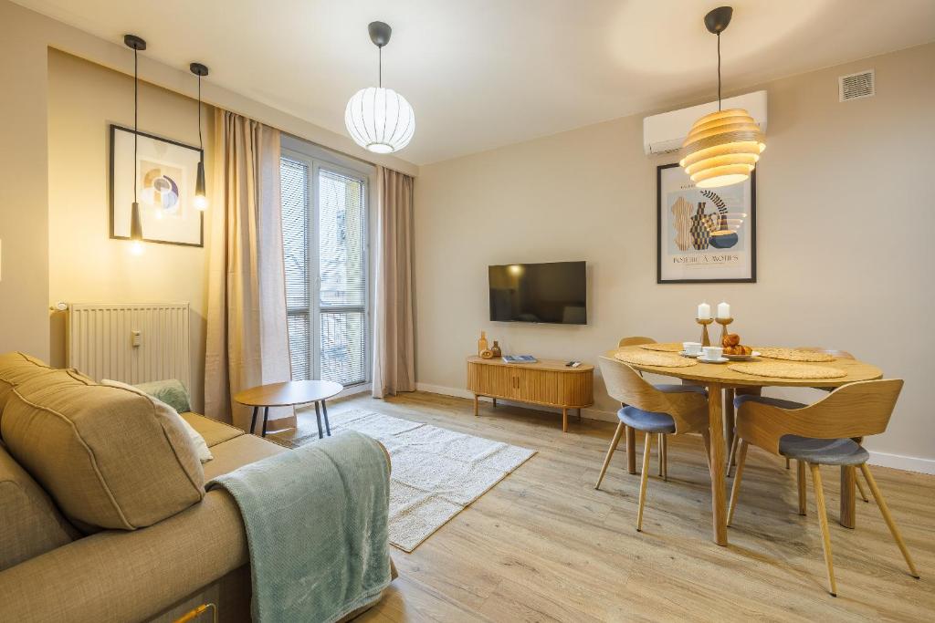 a living room with a couch and a table at Butique Apartament - Old Town in Rzeszów