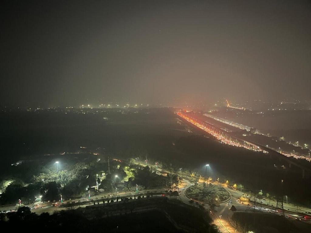 an aerial view of a city at night at Sukoon by Urban Retreat in New Delhi