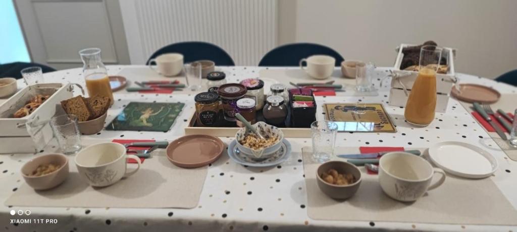 a table with cups and dishes on top of it at Château Vieux Clos Saint Émilion in Saint-Émilion