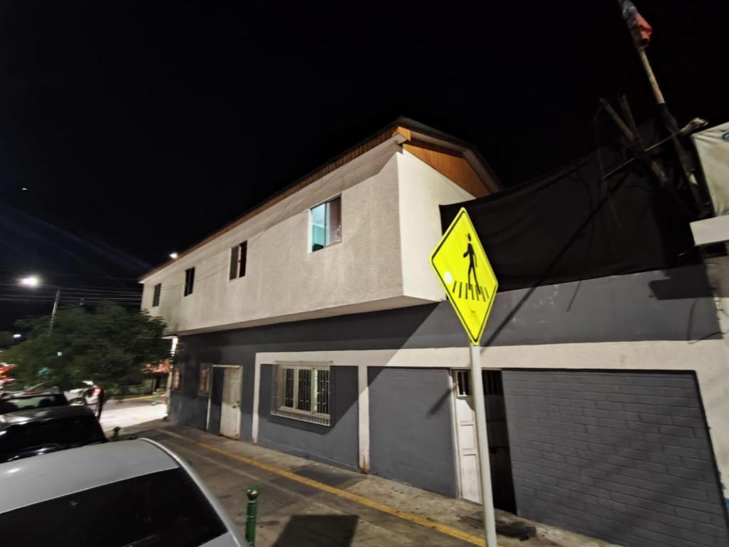 a yellow street sign in front of a building at Donde PATO in Iquique