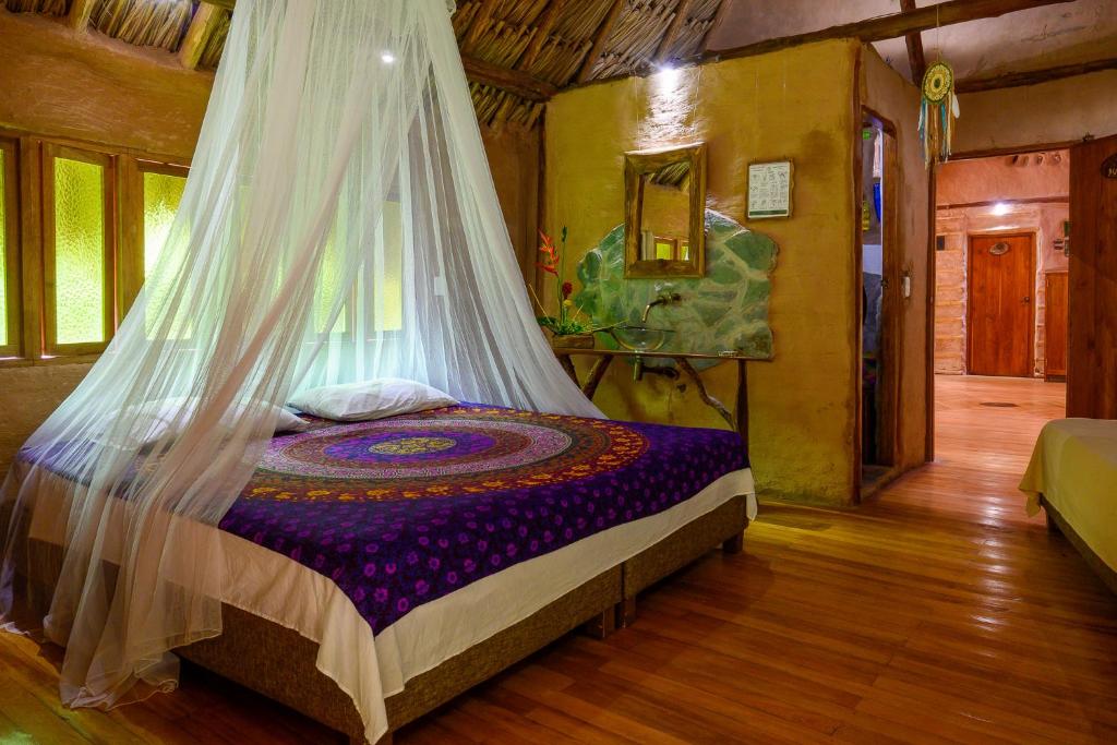 Postel nebo postele na pokoji v ubytování Ecolodge Cosmogénesis