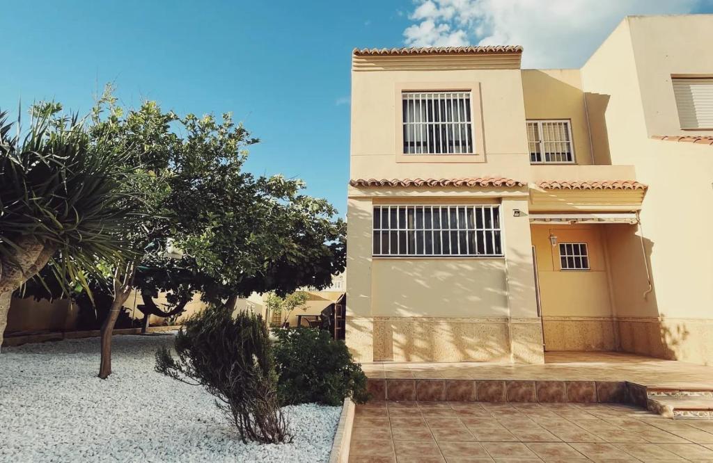 a house with a tree in front of it at Casa La Higuera in Retamar
