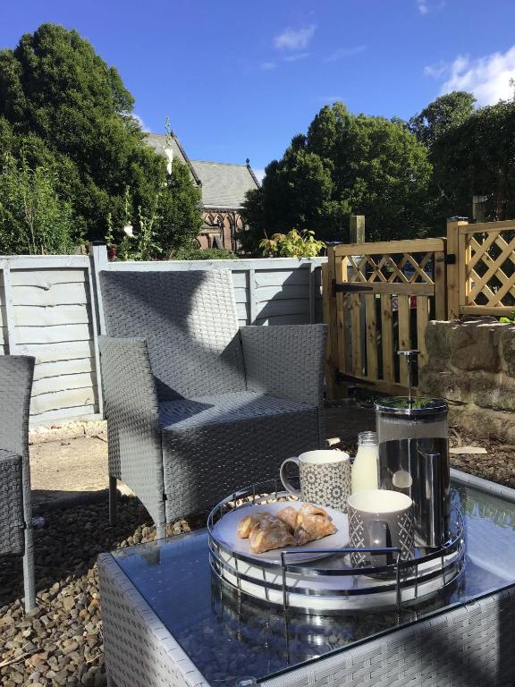 a table with a tray of food on a patio at Cherry Tree Villa in Harrogate