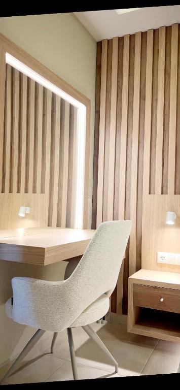 a desk with a white chair and a mirror at Ioannina Center Apartment in Ioannina