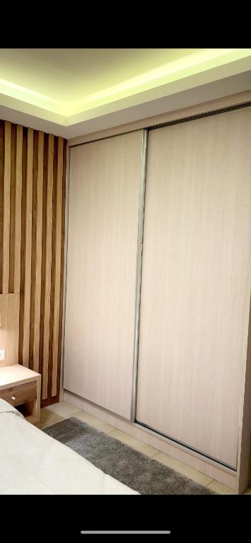 a room with two sliding doors in a bedroom at Ioannina Center Apartment in Ioannina