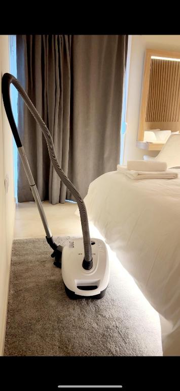 a room with a bed with a white iron on the floor at Ioannina Center Apartment in Ioannina