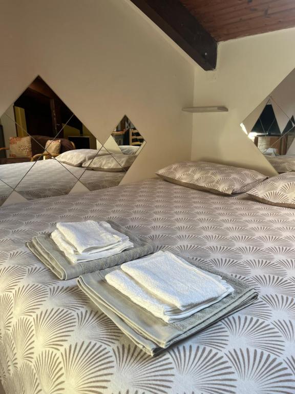 a bed with folded towels on top of it at Casa Parco Dora Torino - Intero Monolocale vicino al Centro e Allianz Stadium Juventus in Turin