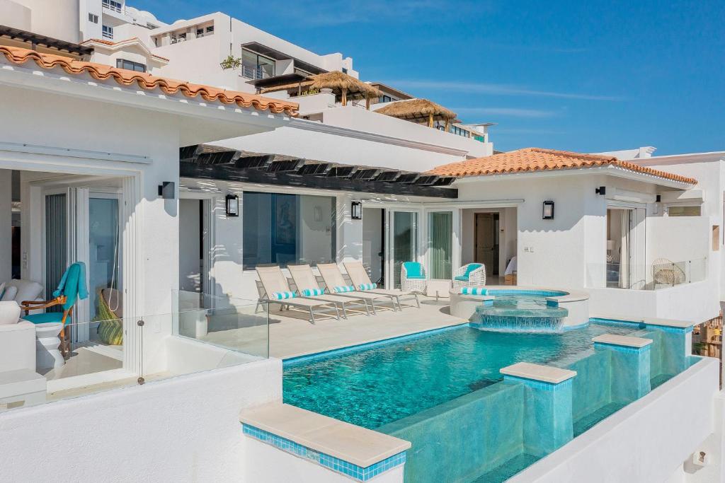 a villa with a swimming pool and a house at Villa Esencia Del Mar in Cabo San Lucas