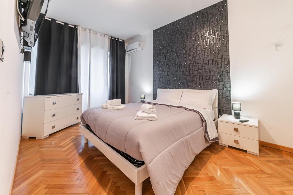 a bedroom with a bed and a large window at Desiré Flat - Vatican City - Metro Cipro and WiFi in Rome