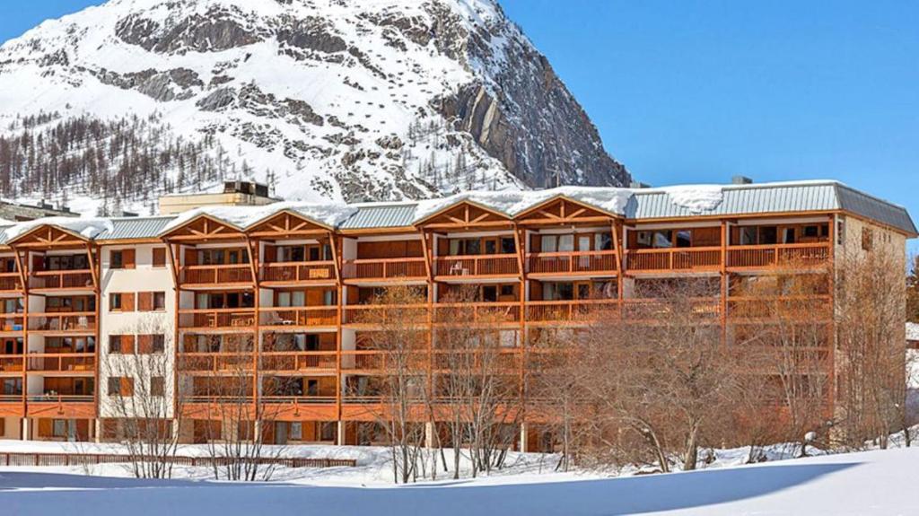 un edificio frente a una montaña nevada en Résidence Les Crêts 1 - Val-d'Isère, en Val dʼIsère