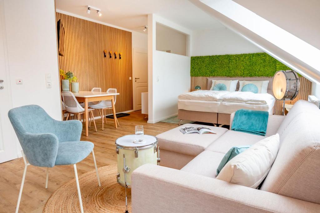 a living room with a couch and a bed at Ferienhof Taarstedt Mikkey in Taarstedt
